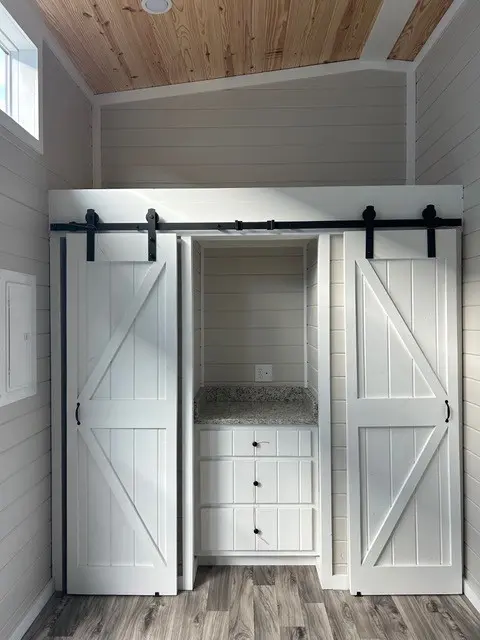 Closet with white sliding barn doors
