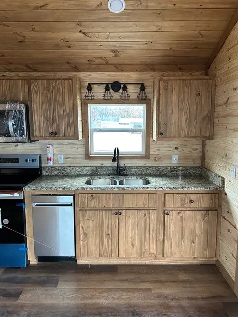 Pine kitchen with stainless appliances and a window over the sink