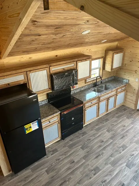 Kitchen with black appliances and a refrigerator