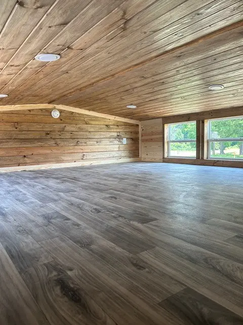 Open living area with a pine ceiling and luxury vinyl plank flooring